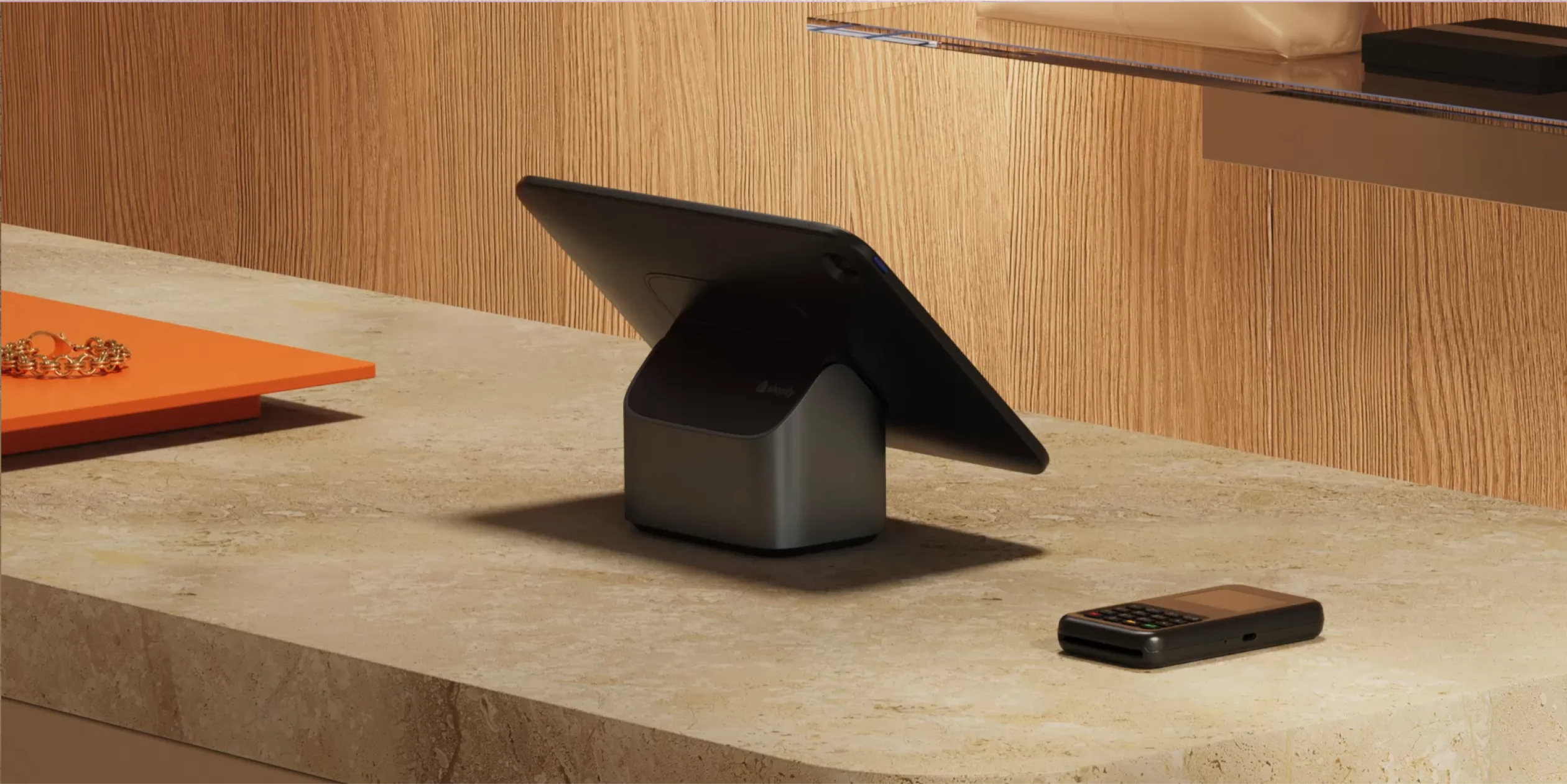A tablet mounted on a retail counter with the WisePad 3 sitting next to it.